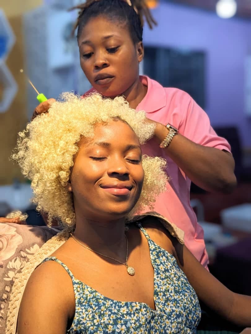 A satisfied hair styling client at Sifmax Beauty Parlour Dar es Salaam